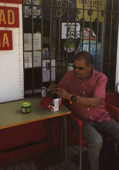 A man sitting outside a café